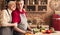 Grateful senior woman hugging her husband at kitchen