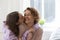 Grateful teen daughter kiss happy young mother