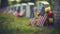 A grave with an american flag and colorful flowers are noticeable in the background for memorial day