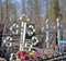 Grave crosses in the cemetery illuminated by the sun