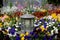 Grave lantern with many colorful spring flowers