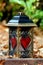Grave lantern with red hearts of glass