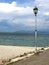 Gravel beach with latern, Lake Garda and rain clouds