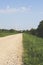 Gravel bicycle road on a sunny morning with bridge ahead