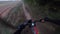 Gravel mountain bike on a forest sand path driver point of view