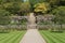 A gravel path runs between two verdant lawns before rising up several flights of steps and terraced gardens in the formal gardens