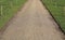 Gravel pathway with simple wood and rope fences to either side