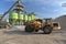 Gravel pit: building and wheel loader loading gravel onto a truck