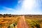 Gravel road in Australian outback in bright sunshine