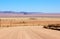 Gravel road through the golden dune