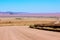 Gravel road through the golden dune