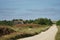 Gravel road in Jutland, heather wilderness landscape on sunny day