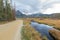 Gravel road passes a Beaver Pond in Idaho forest