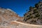 Gravel road and rocky peaks in the Lefka Ori mountains on the island of Crete