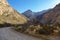 Gravel road through Seweweekspoort with last rays of sunlight over the mountain