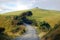 Gravel road turn left at rural area near water tank on hill top