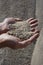 Gravel sand in man hands in quarry background