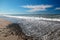 Gravel and Seafoam waves on beach at McGrath State Park in Ventura - Oxnard California USA