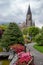 The gravel walkway in beautiful garden leading to the medieval europe style church