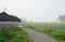 Graveled path before farmhouse in spring morning