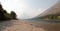 Gravelly shoreline of Upper Two Medicines Lake in Glacier National Park during the 2017 fall forest fires in Montana USA