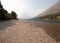 Gravelly shoreline of Upper Two Medicines Lake in Glacier National Park during the 2017 fall forest fires in Montana USA