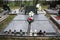 Graves, tombstones and crucifixes on traditional cemetery. Votive candles lantern and flowers on tomb stones in graveyard