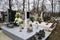 Graves, tombstones and crucifixes on traditional cemetery. Votive candles lantern and flowers on tomb stones in graveyard