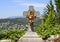 Gravestone with cross and sculptured flowers in the cemetery in Saint Paul-De-Vence, Provence, France