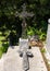 Gravestone with ornate cross and cross bearing Jesus in the cemetery in Saint Paul-De-Vence, Provence, France