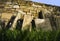 Gravestones lit by sun placed near a wall