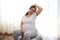 Gravid pregnant expectant woman, future mother expecting baby, practicing prenatal stretching exercising on a fit ball