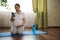 Gravid woman checks mobile app on her smartphone, searching on internet yoga and breath exercises for healthy pregnancy