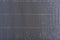 Gray abstract striped background. Rough texture. Perforated paper