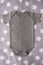 Gray baby bodysuit mock up on a grey background with stars