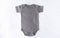 Gray baby bodysuit mock up with on a white cotton background