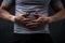 Gray backdrop highlights closeup of man with stomach ache, red point