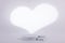 Gray background with a white heart shape behind for product commercial light shape