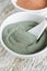 Gray bentonite clay powder in the white bowl. Diy facial mask and body wrap recipe. Natural beauty treatment and spa