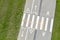 Gray bicycle lane. white markings and signs. green grass background. aerial view