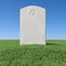 Gray blank gravestone on green grass under blue sky