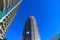 A gray and blue skyscraper and office buildings with metal balconies with gorgeous deep blue sky in downtown Atlanta