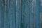 Gray blue wooden texture of thin frayed fence boards