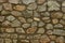 Gray brown stone texture of large cobblestones in the wall