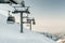 Gray cable car lift at ski resort.
