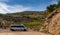 Gray camper van parked in the Andalusian backcountry near the idyllic whitewashed village of Enix