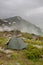 Gray camping tent in the mist.