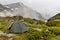 Gray camping tent in mountains.