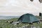 Gray camping tent in mountains.