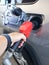 Gray car at gas station being filled with fuel The driver fills up his car with gasoline